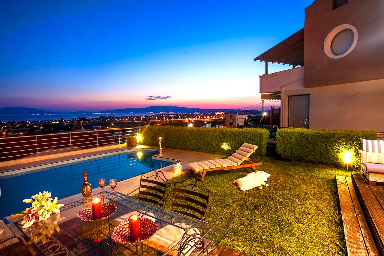 Experience a tranquil sunset by the pool with stunning views in Greece.